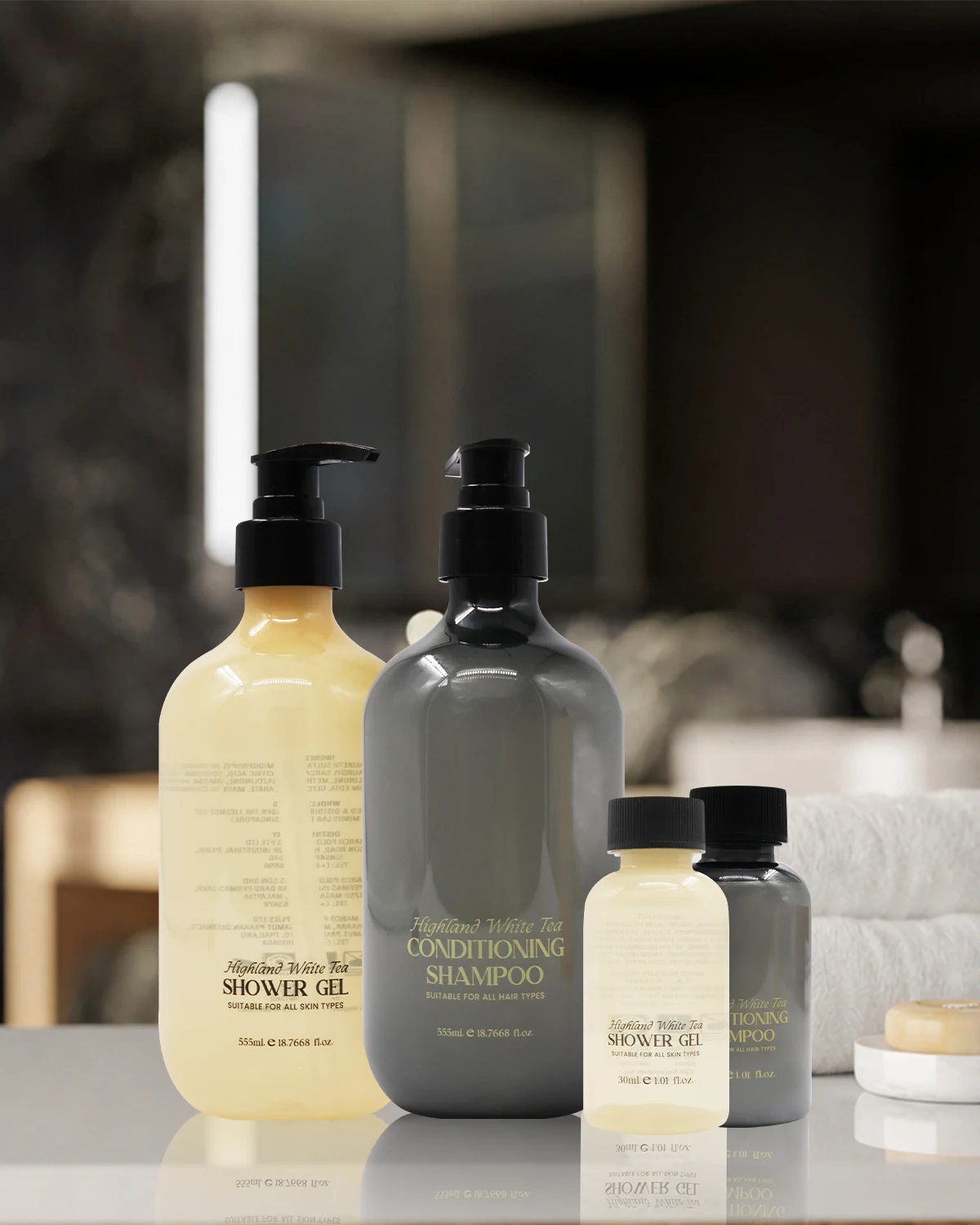 Highland White Tea bath and body formats arranged on a bathroom counter.