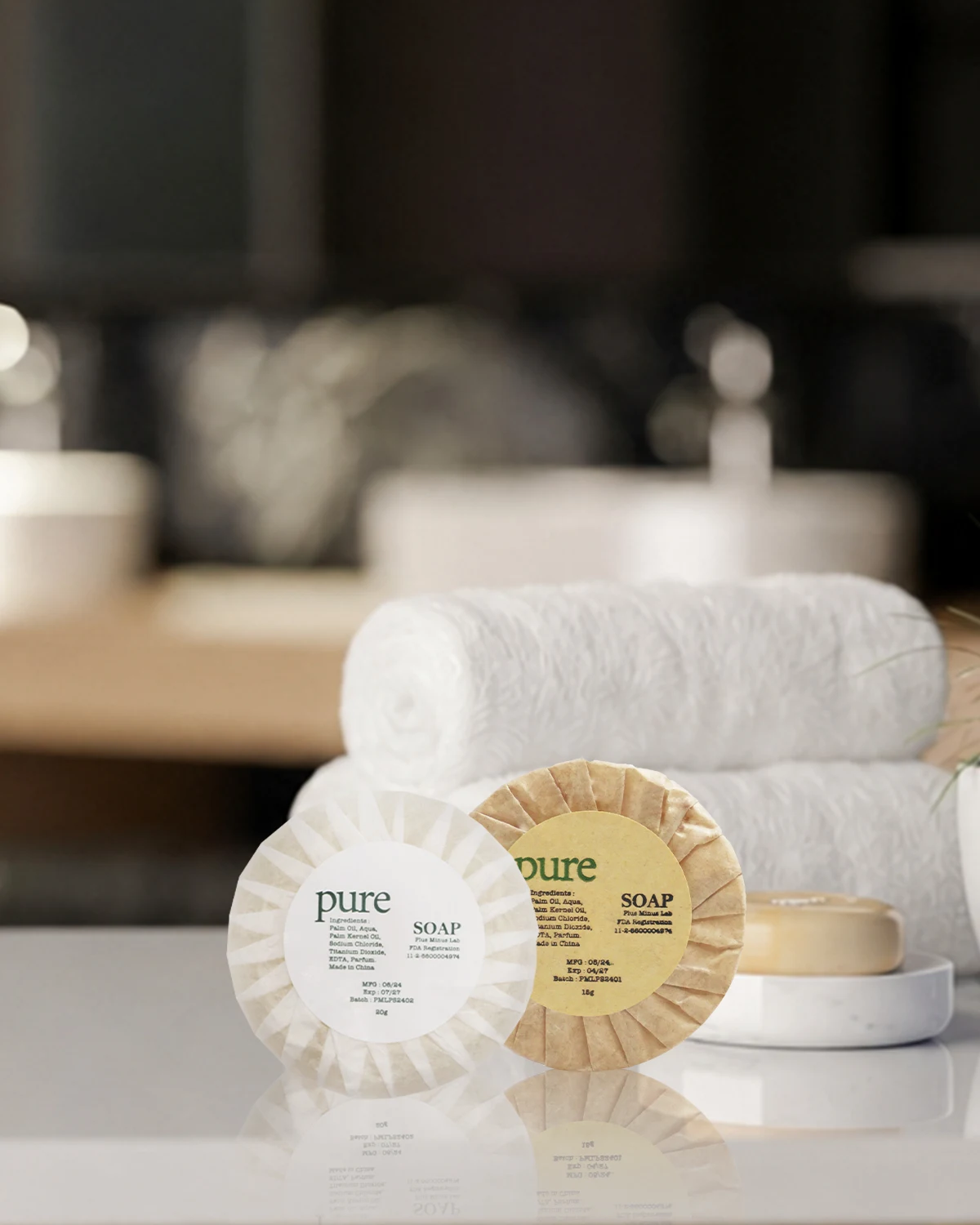 Two round wrapped soaps arranged in a hotel guest room.